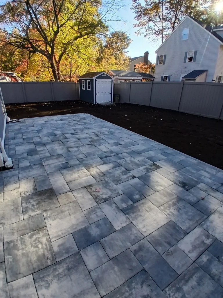Newly installed paver patio and landscaping by Cut Above Landscaping, Inc.