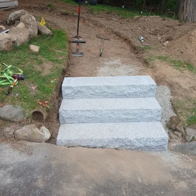 Newly installed granite steps and walkway during landscaping project in Billerica, MA.