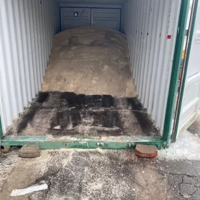 Container filled with salt for ice melt application, supporting commercial snow management services for safe surfaces in winter.